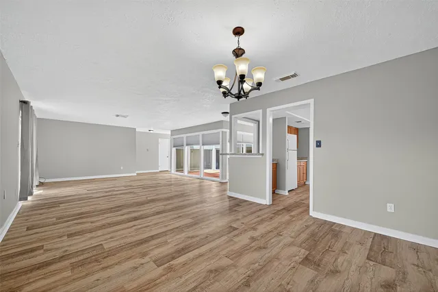 a view of livingroom with hardwood floor and kitchen view