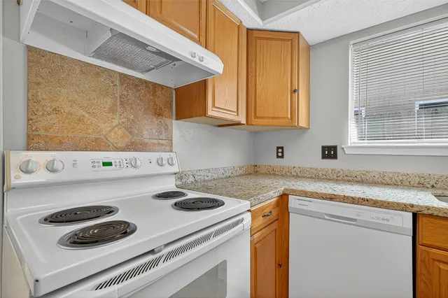a kitchen with a stove and a sink