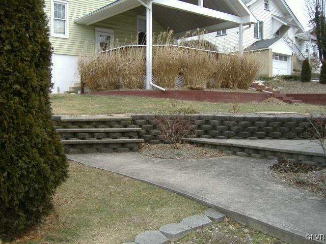 Patio/walkway leading to garage