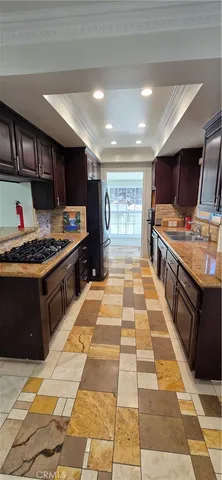 a kitchen with a sink a stove cabinets and a window