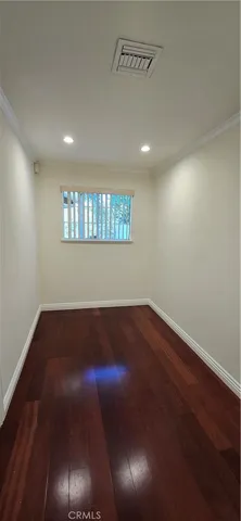 a view of a livingroom with wooden floor and a window