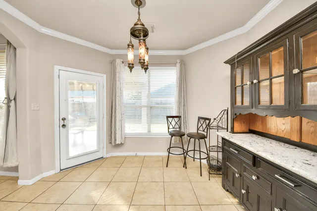 a view of an entryway with wooden floor and livingroom