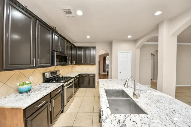 a large kitchen with granite countertop lots of counter top space