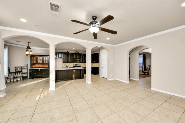 a living room with stainless steel appliances kitchen island granite countertop furniture and a kitchen view