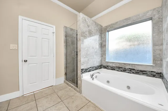 a bathroom with a bathtub and shower