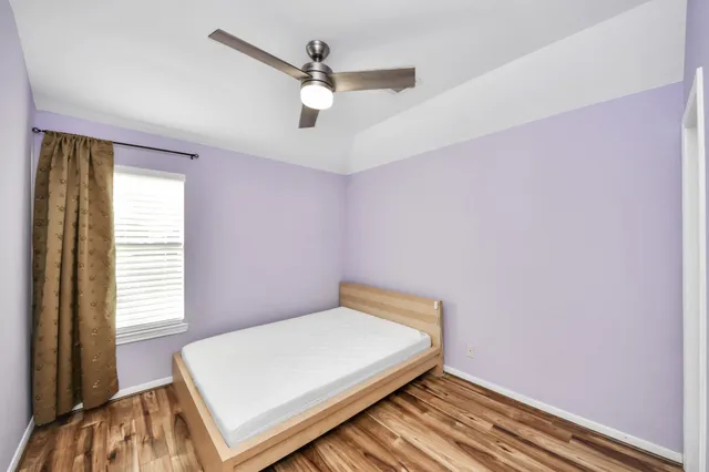 a bed room with a bed and a window