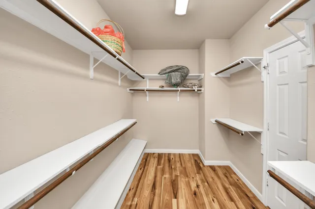 a view of backyard with table and chairs and wooden fence