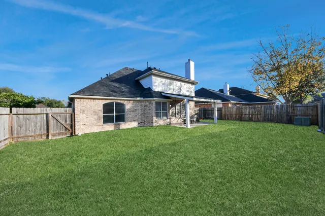 a view of a house with backyard porch and sitting area