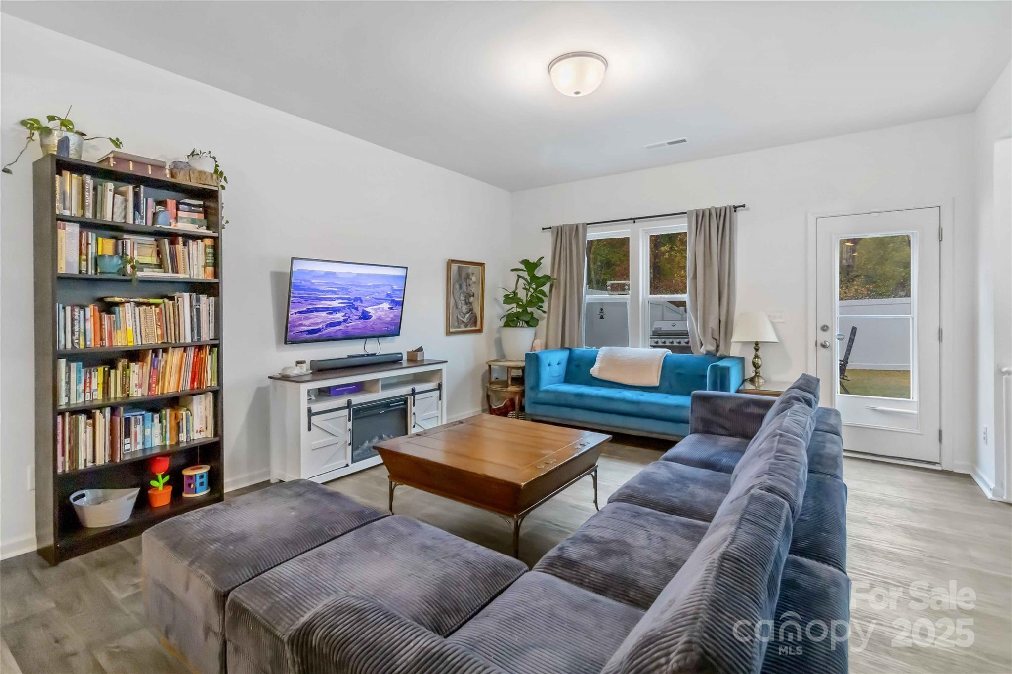 684 Candela Court York, SC 29745 - Photo 11 of 28 a living room with furniture workspace and a bookshelf