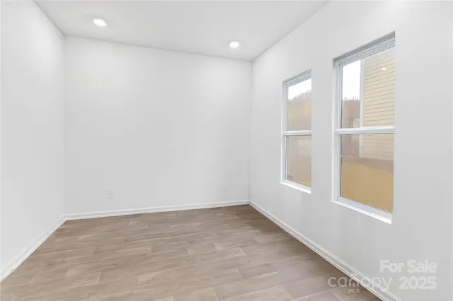 a bedroom with a bed and a television