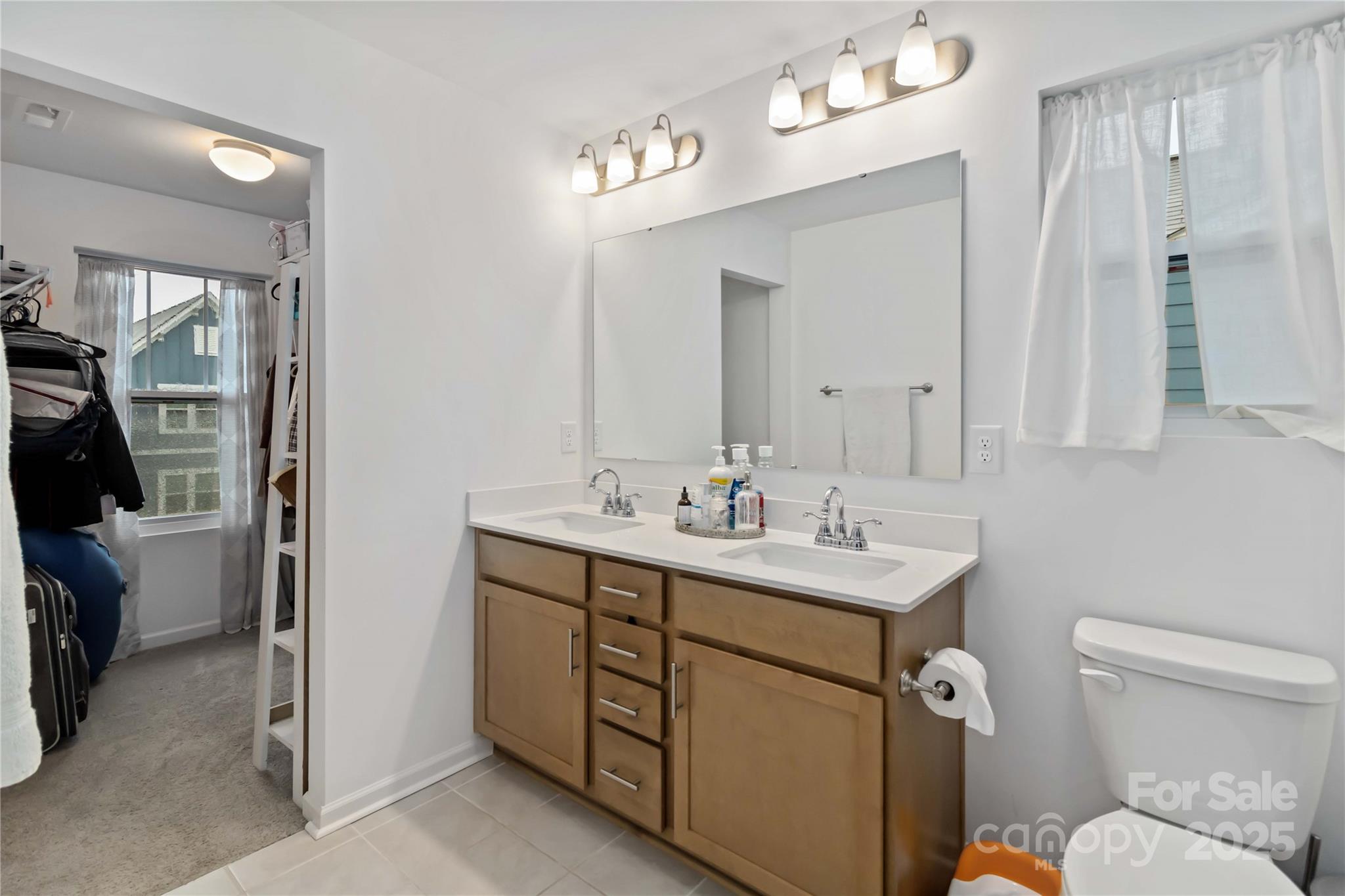 684 Candela Court York, SC 29745 - Photo 22 of 28 a bathroom with a toilet sink and mirror
