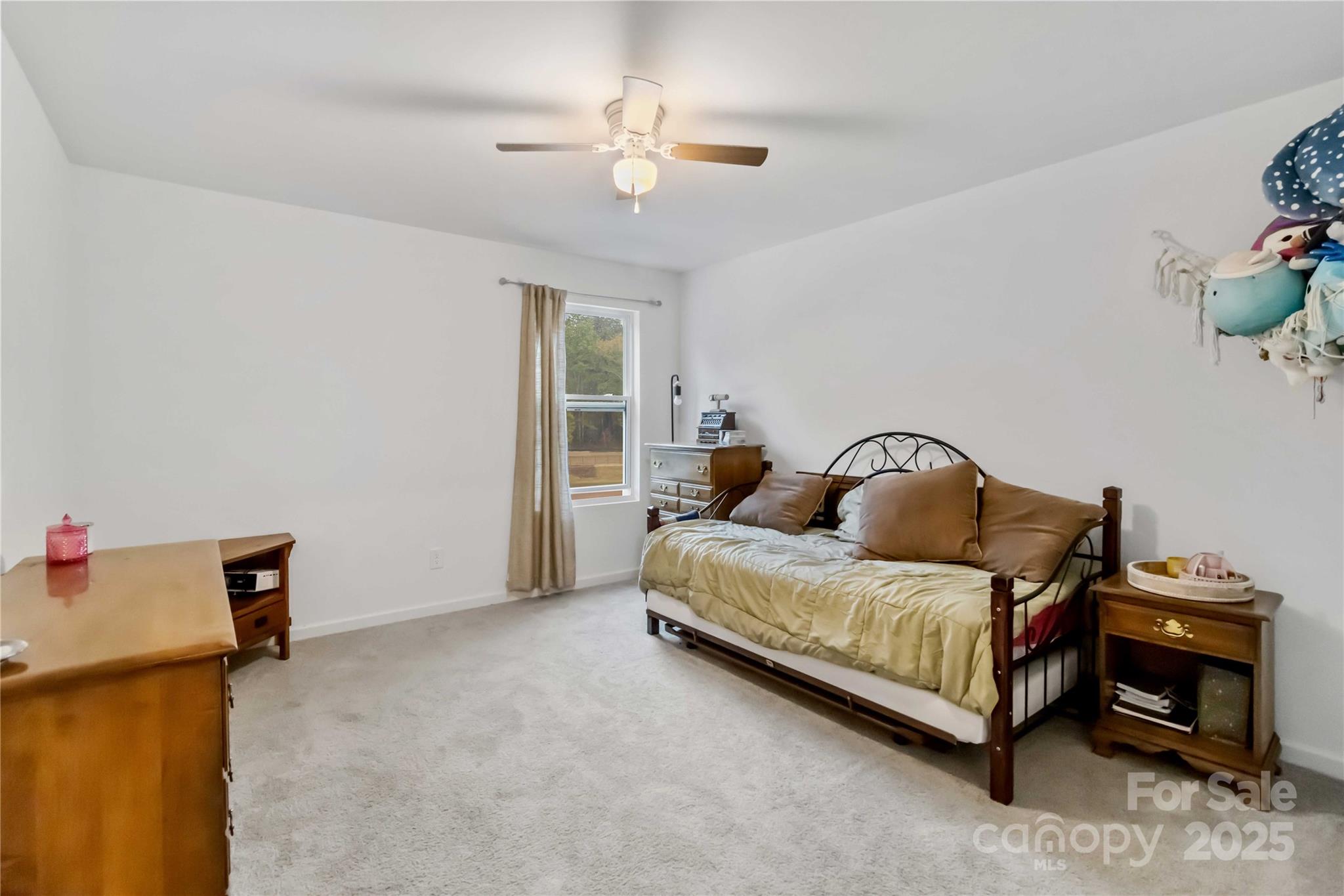 684 Candela Court York, SC 29745 - Photo 26 of 28 a bedroom with a bed and a chandelier