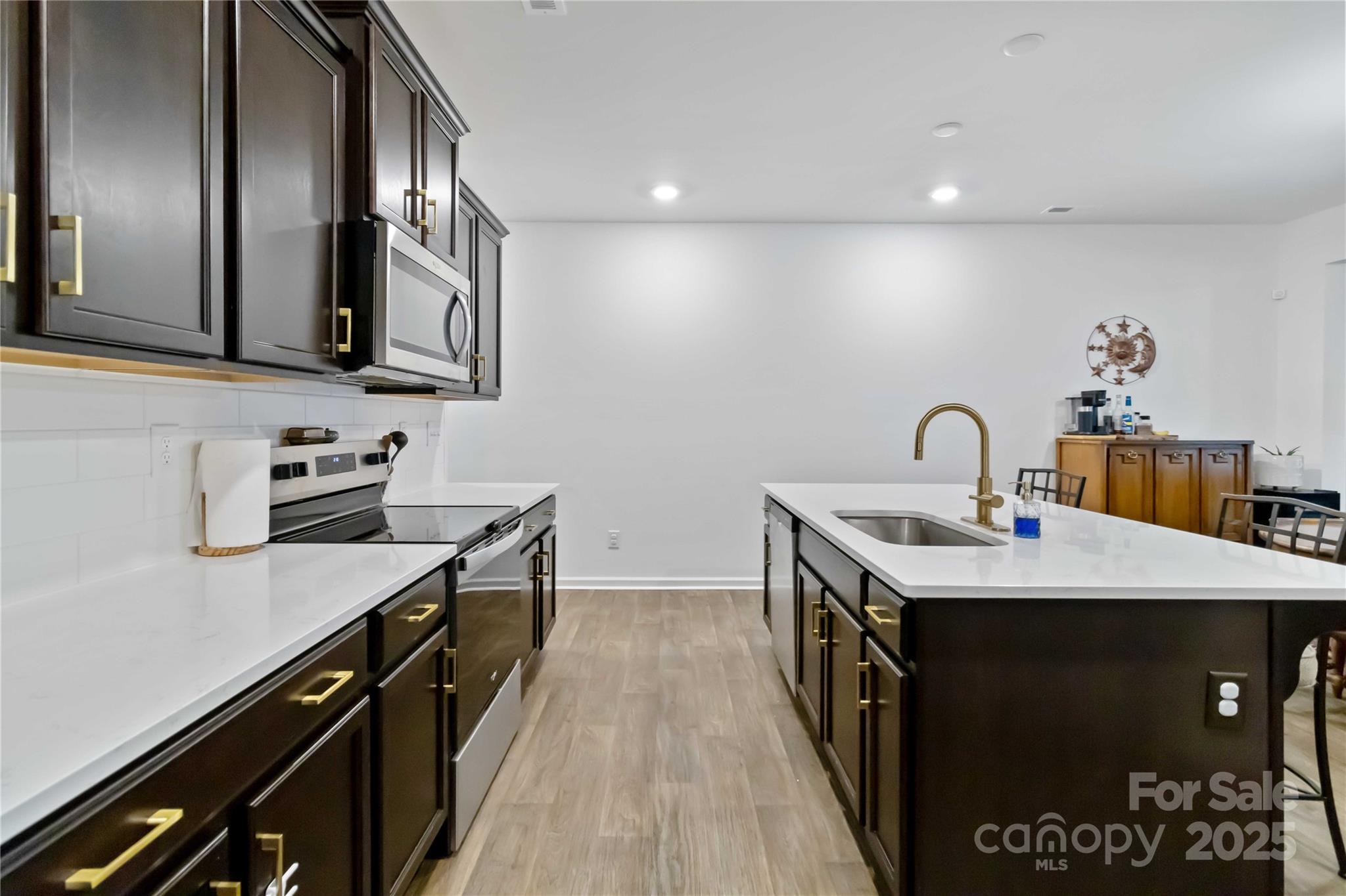 684 Candela Court York, SC 29745 - Photo 4 of 28 a kitchen with a sink stove and cabinets