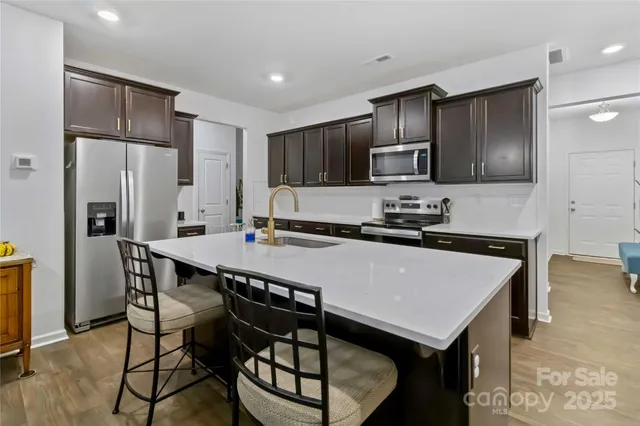 a dining room with furniture and a chandelier