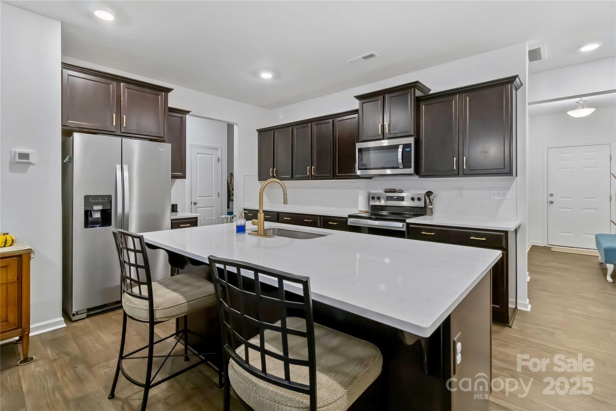 684 Candela Court York, SC 29745 - Photo 5 of 28 a kitchen with a refrigerator a stove a sink and a cabinets