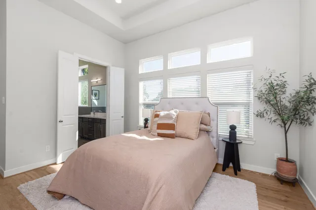 a bedroom with a bed and a potted plant