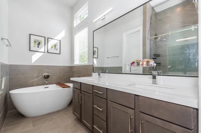 a bathroom with a bathtub sink and mirror