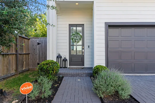 a view of a backyard with potted plants and wooden fence