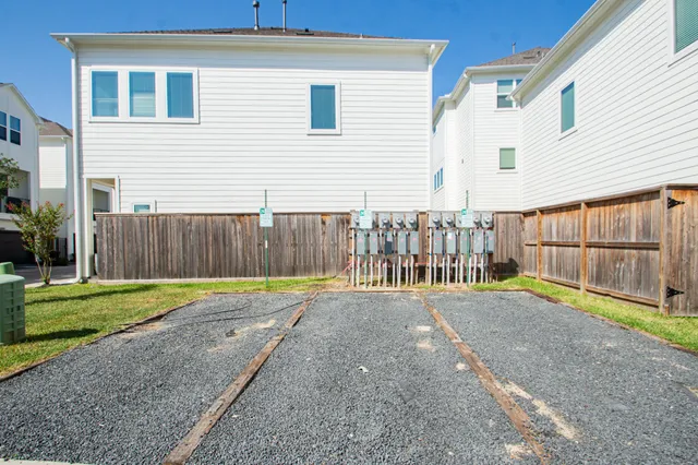a view of backyard with wooden fence
