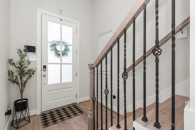 a view of entryway with wooden floor and stairs