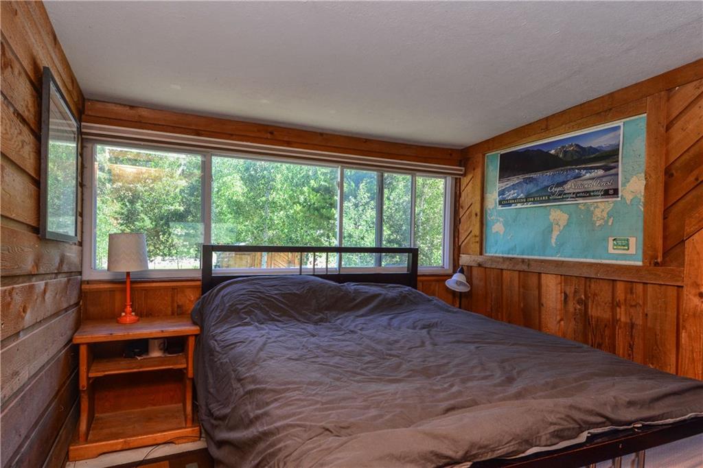 89 V Road Silverthorne, CO 80498 - Photo 14 of 25 a bed sitting in a bedroom next to a window