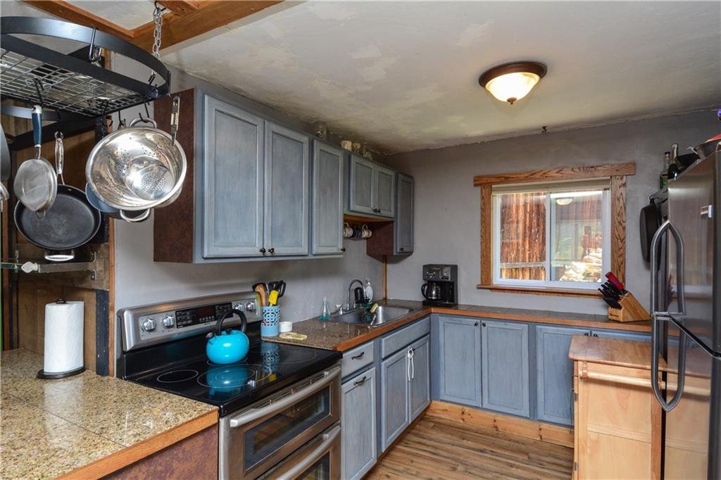 89 V Road Silverthorne, CO 80498 - Photo 3 of 25 a kitchen with stainless steel appliances granite countertop a stove a sink and a microwave