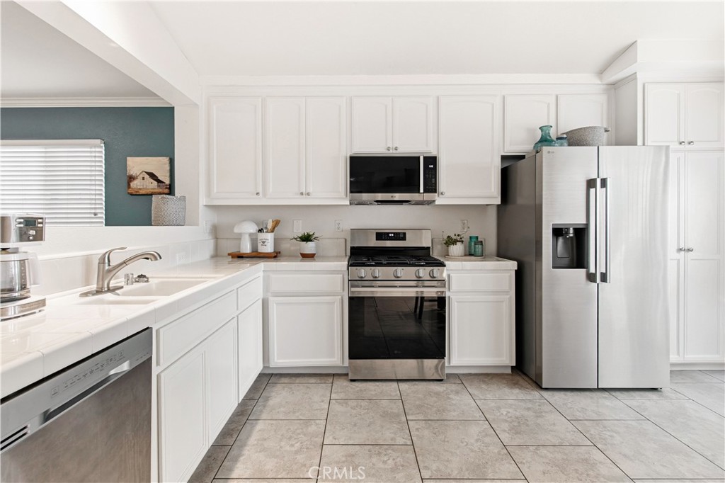 1478 La Sierra Street Merced, CA 95348 - Photo 12 of 32 a kitchen with stainless steel appliances granite countertop a refrigerator sink and stove