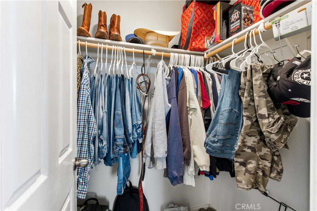 1478 La Sierra Street Merced, CA 95348 - Photo 20 of 32 a view of walk in closet with clothes and shoes