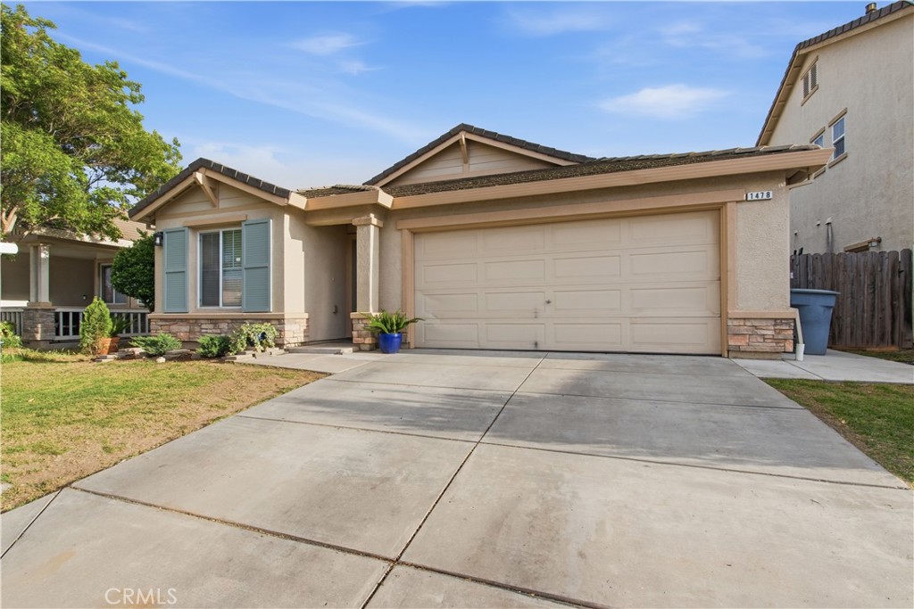 1478 La Sierra Street Merced, CA 95348 - Photo 2 of 32 a front view of a house with a yard and garage