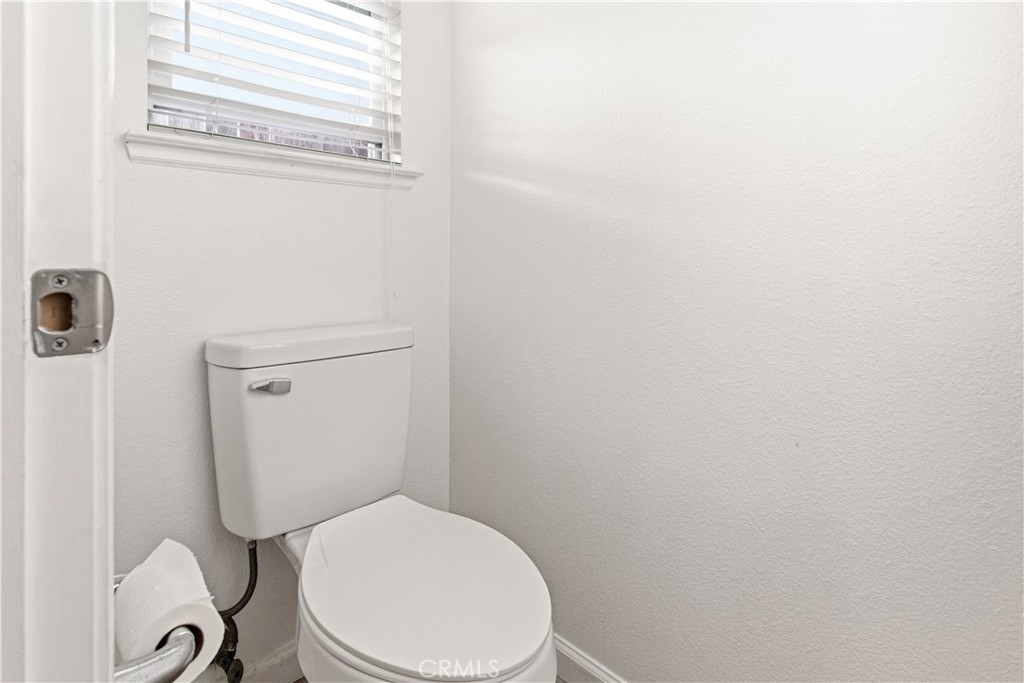 1478 La Sierra Street Merced, CA 95348 - Photo 22 of 32 a white toilet sitting next to a shower
