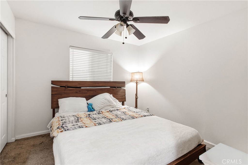 1478 La Sierra Street Merced, CA 95348 - Photo 25 of 32 a bedroom with a bed and a ceiling fan