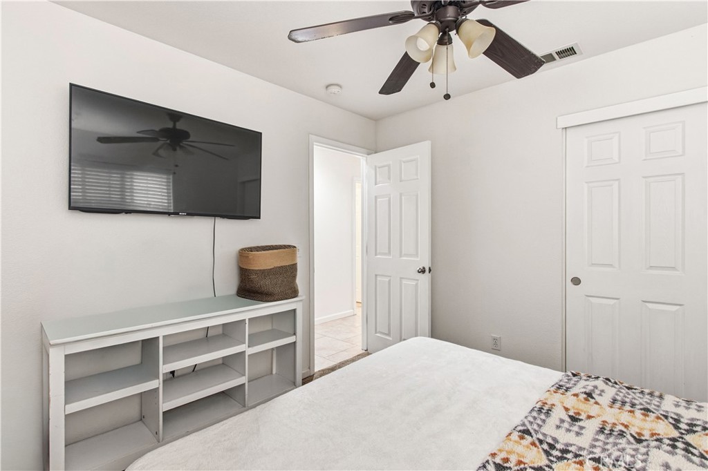 1478 La Sierra Street Merced, CA 95348 - Photo 26 of 32 a bedroom with a bed and a flat screen tv