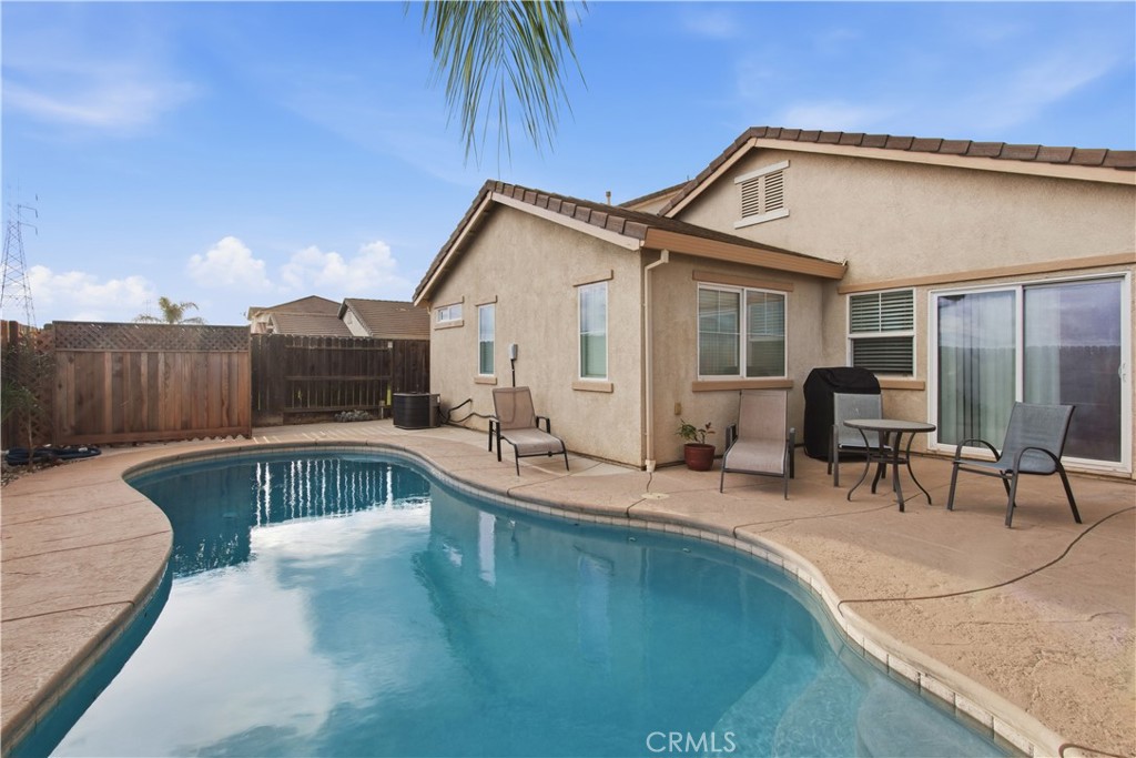 1478 La Sierra Street Merced, CA 95348 - Photo 4 of 32 a view of a house with swimming pool and sitting area