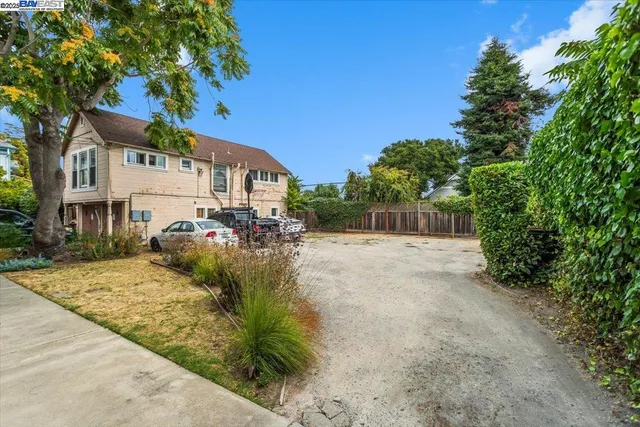 a view of a street that has parked cars