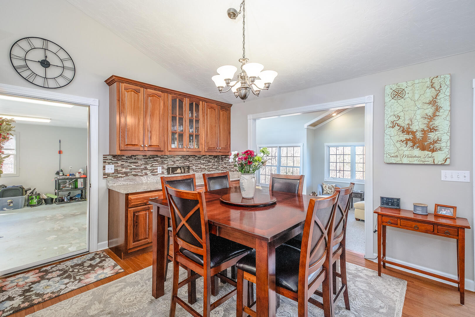 2085 Lakewood Forest Road Moneta, VA 24121 - Photo 20 of 76 a dining room with furniture a chandelier and a rug