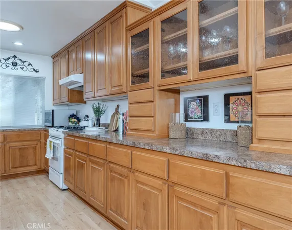 a kitchen with stainless steel appliances granite countertop a sink and cabinets