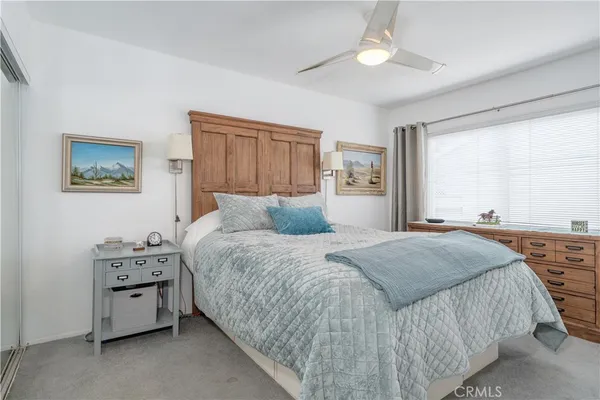 a large bed sitting in a bedroom and a dresser