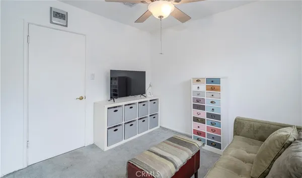 a bedroom with a bed and a ceiling fan