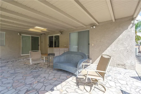 a view of a porch with a table and chairs