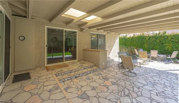 a outdoor space with patio the white wall and chairs