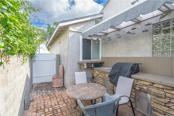 a view of a chairs and table in backyard