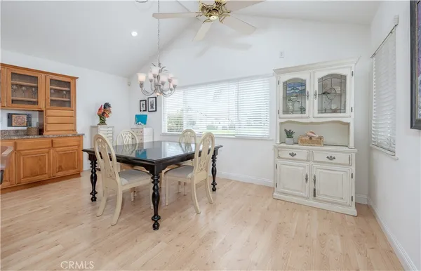 a view of a dining room with furniture and a chandelier