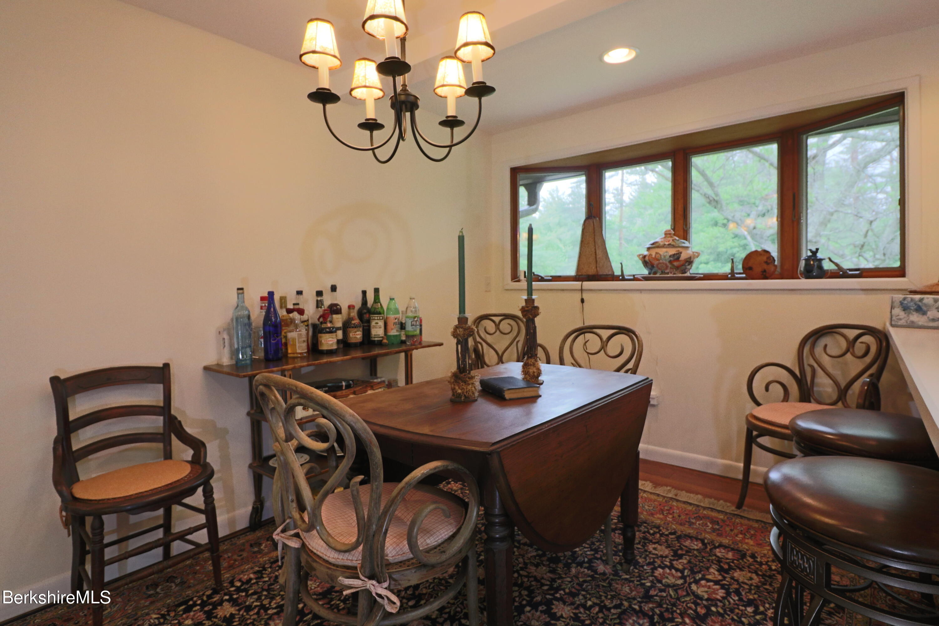 13 Cherry Hill Road Stockbridge, MA 01262 - Photo 16 of 41 a view of a dining room with furniture a chandelier and large windows