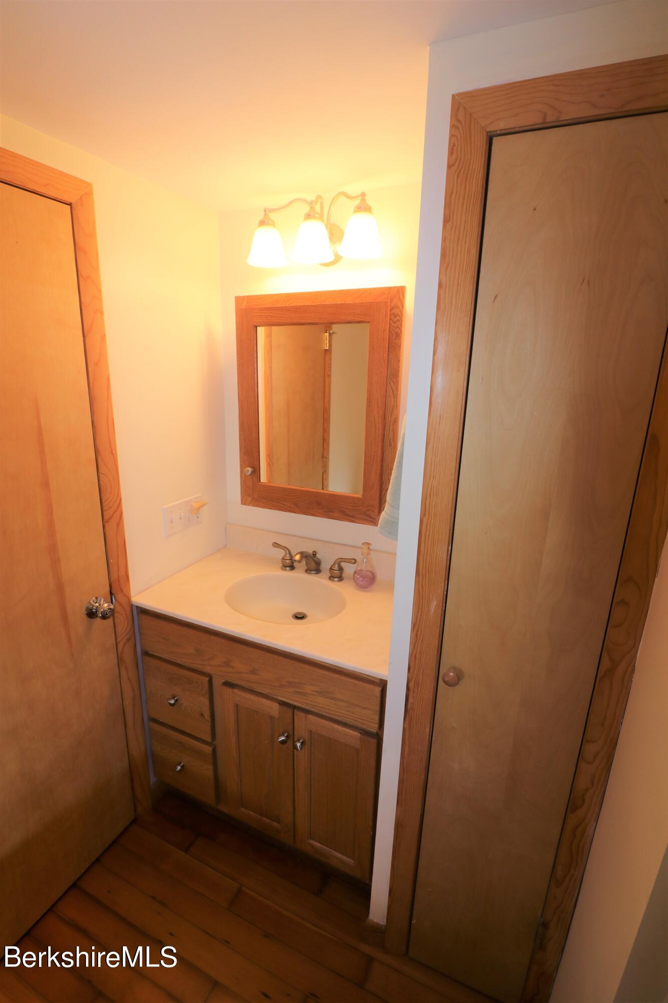 13 Cherry Hill Road Stockbridge, MA 01262 - Photo 28 of 41 a bathroom with a sink a mirror and shower