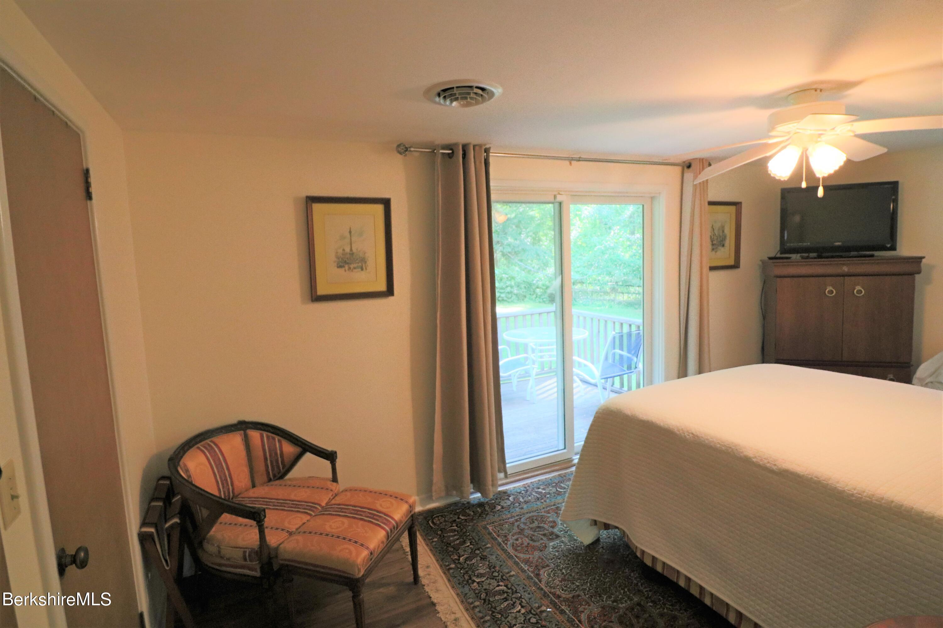 13 Cherry Hill Road Stockbridge, MA 01262 - Photo 30 of 41 a bedroom with a bed and wooden floor