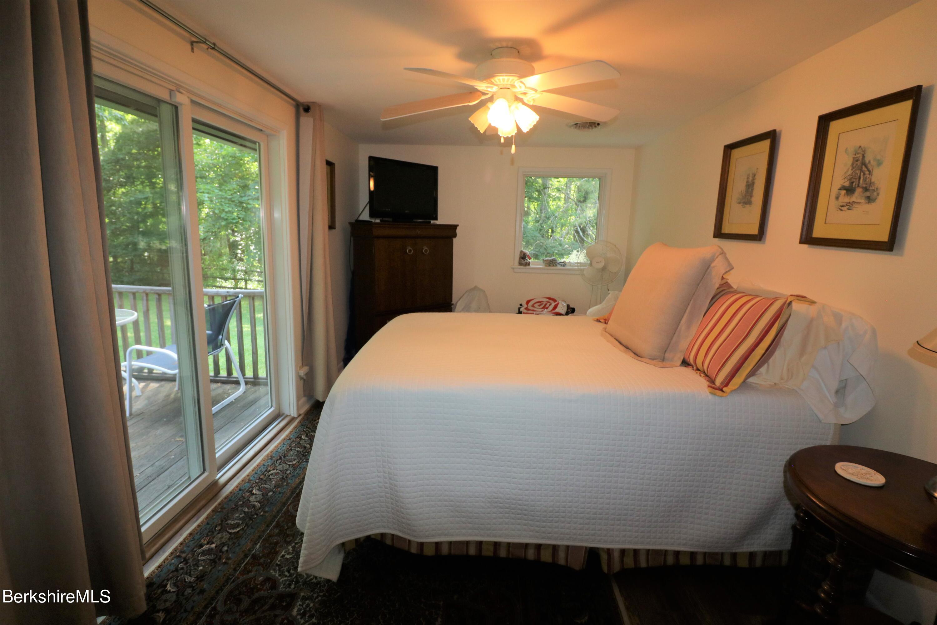 13 Cherry Hill Road Stockbridge, MA 01262 - Photo 31 of 41 a bedroom with a bed and a flat tv screen on dresser