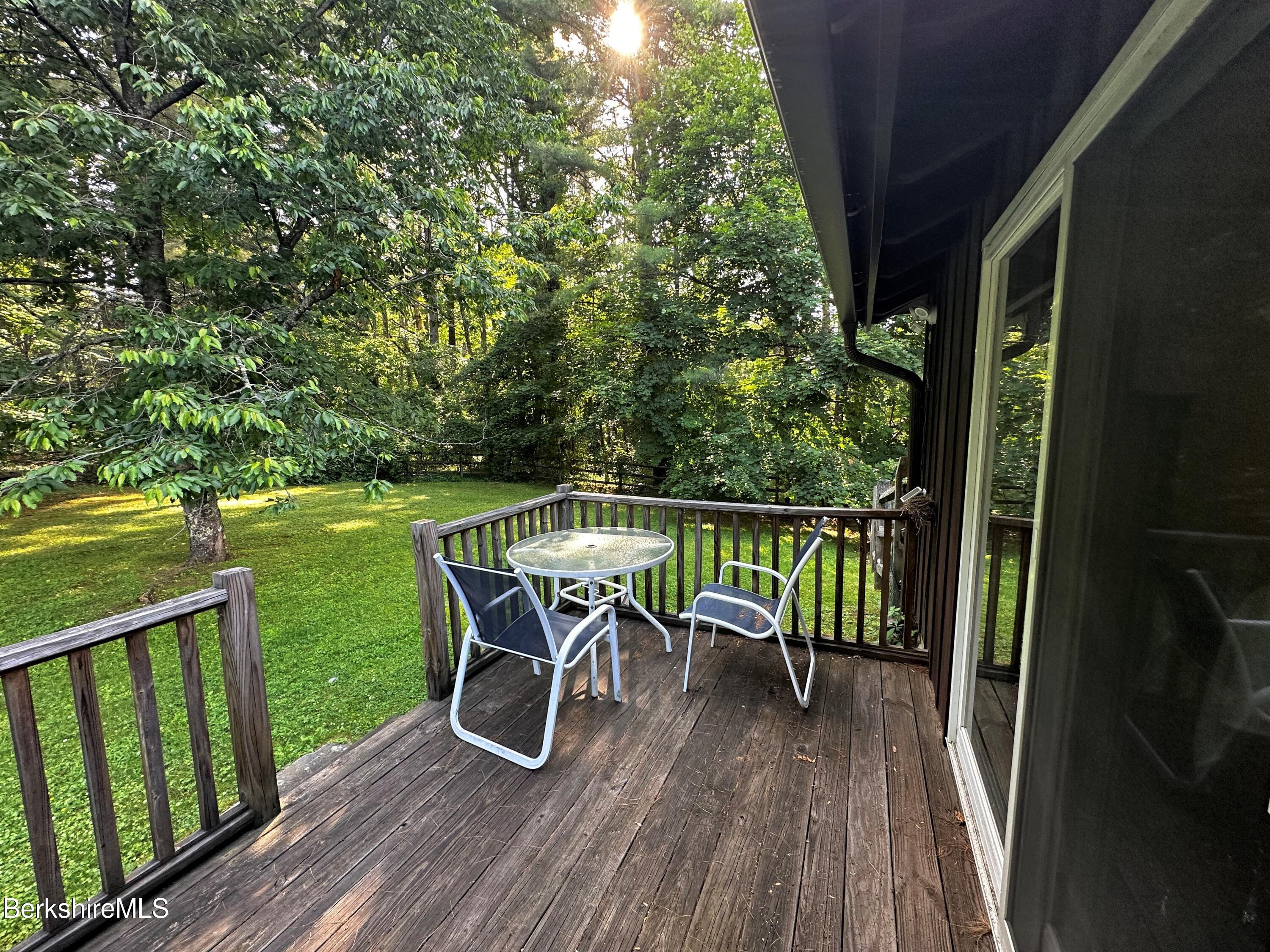 13 Cherry Hill Road Stockbridge, MA 01262 - Photo 6 of 41 a view of a chairs and table on the wooden deck