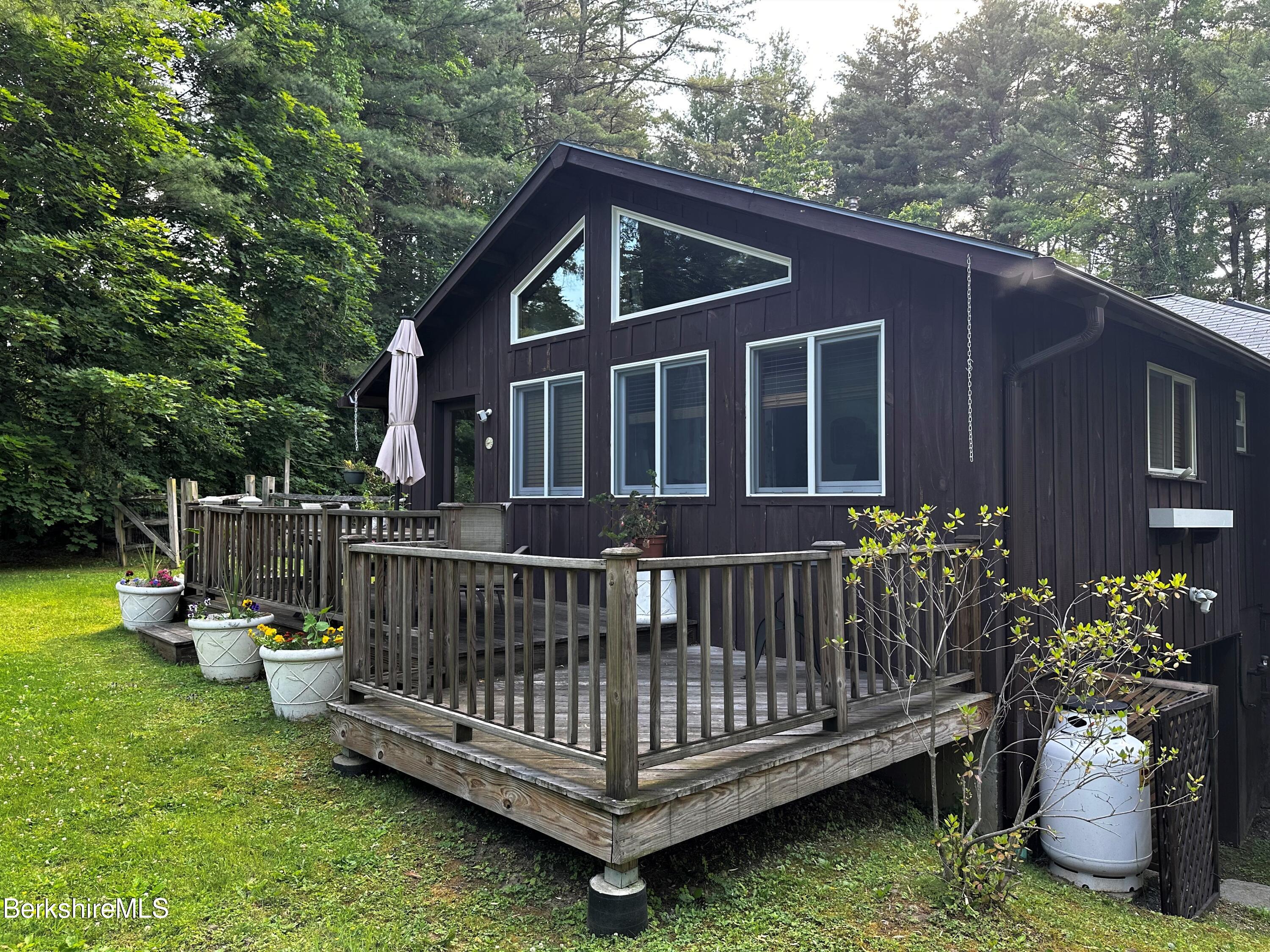 13 Cherry Hill Road Stockbridge, MA 01262 - Photo 8 of 41 a view of a wooden house with a wooden deck and furniture