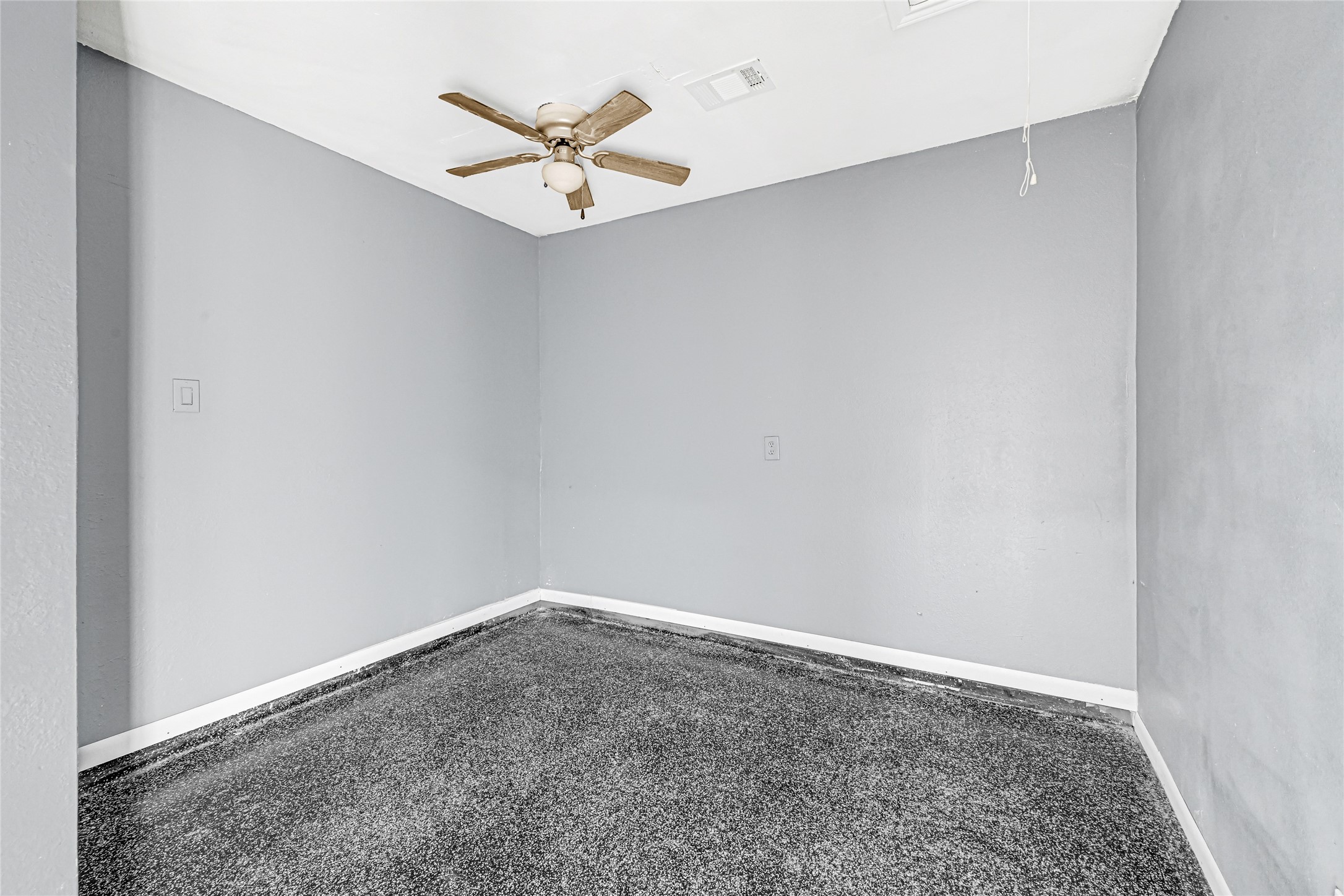 14714 Placid Point Humble, TX 77396 - Photo 7 of 37 This room features light gray walls, epoxy flooring and a ceiling fan, offering a simple and clean space suitable for customization.