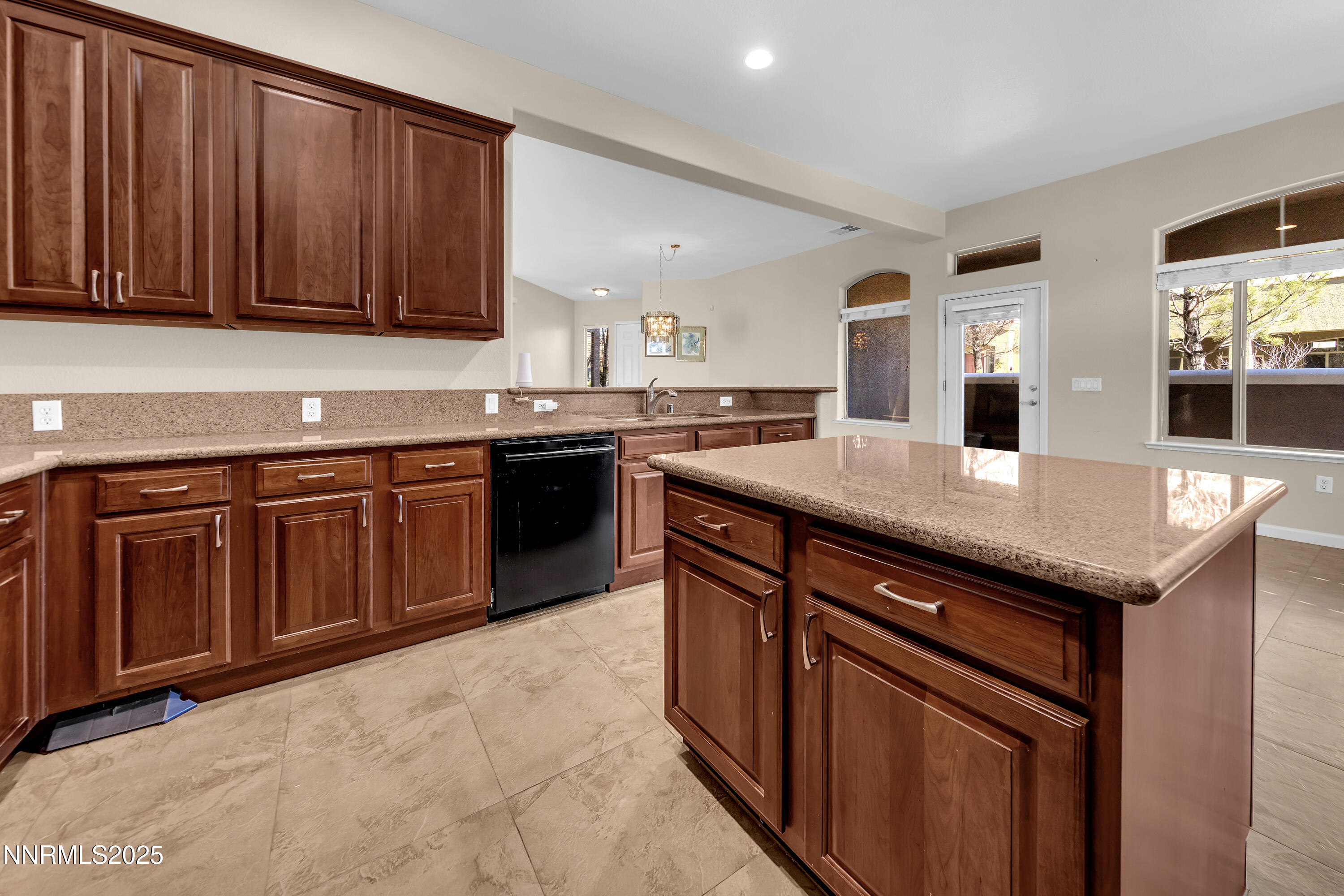 9900 Wilbur May Parkway, Unit 1802 Reno, NV 89521 - Photo 11 of 47 a kitchen with stainless steel appliances granite countertop wooden cabinets a sink and dishwasher